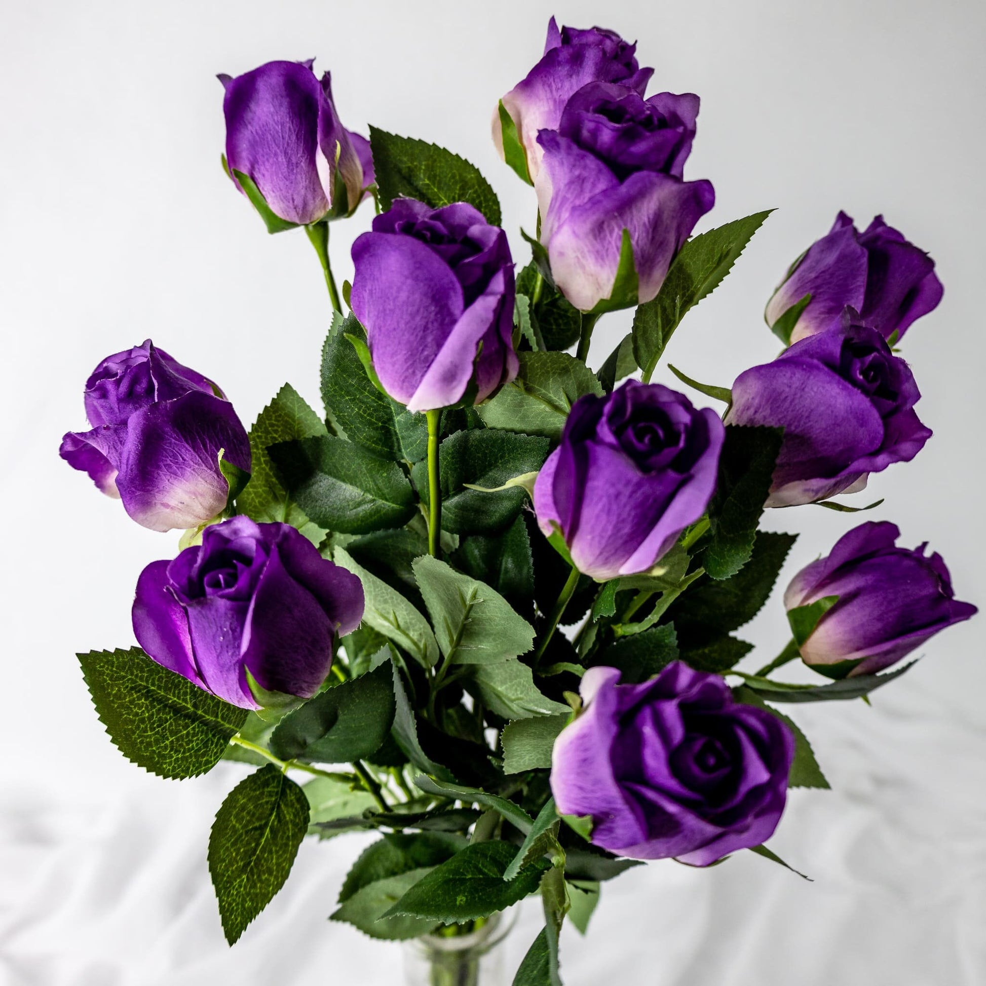 artificial Purple Real Touch Rose Open Buds in glass vase top view