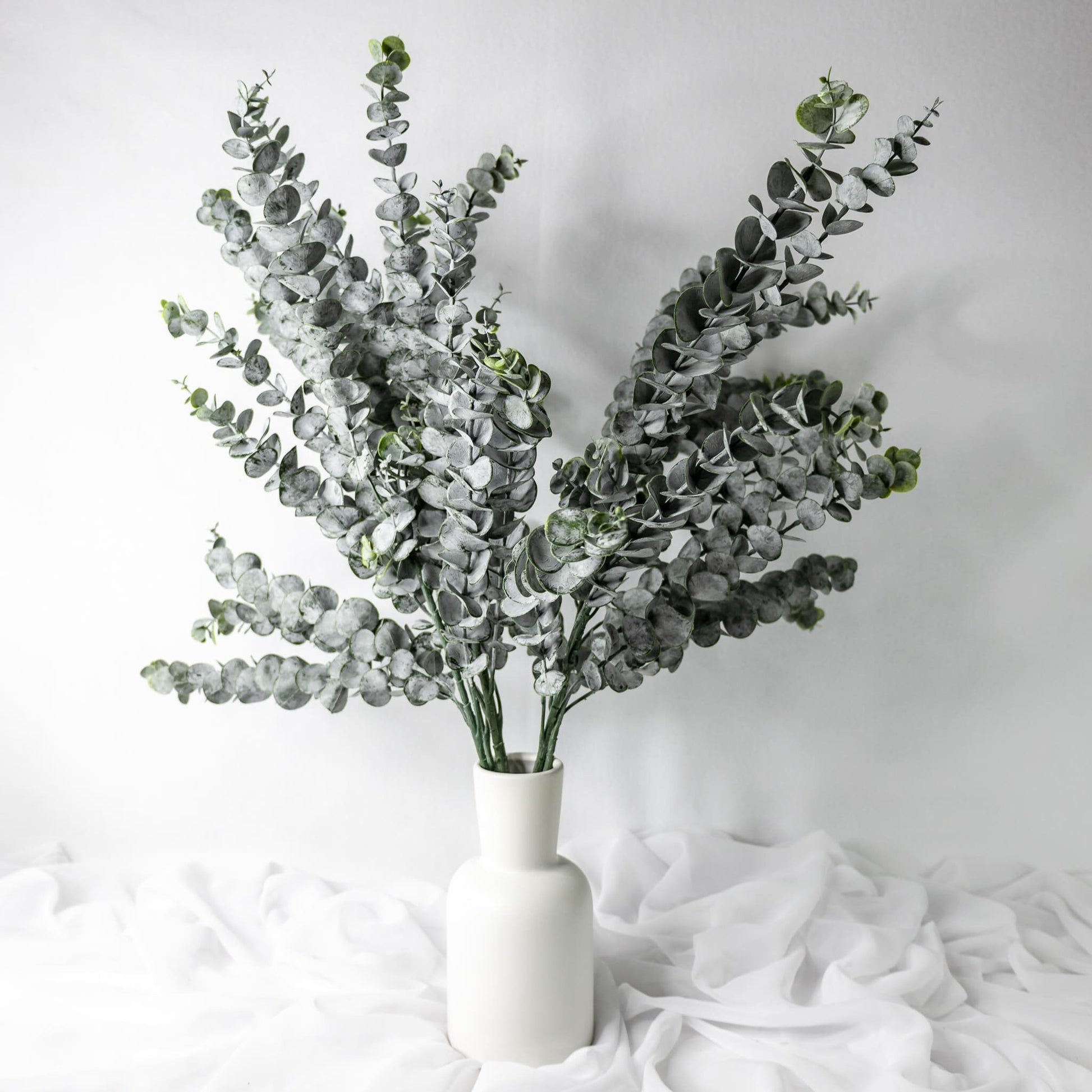 artificial Long Spinning Gum leaves in white vase