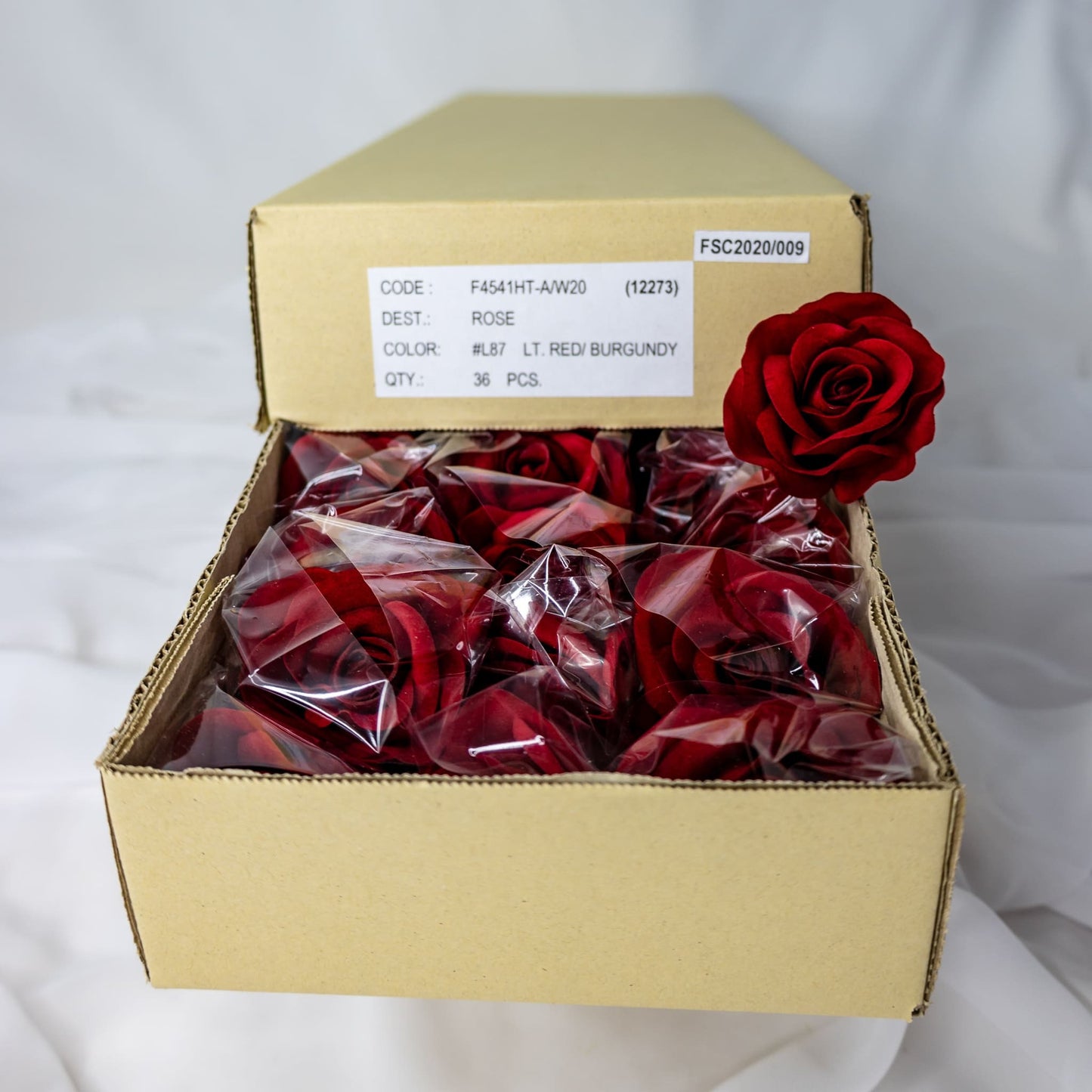 artificial Red Velveteen Bloom roses inside the box