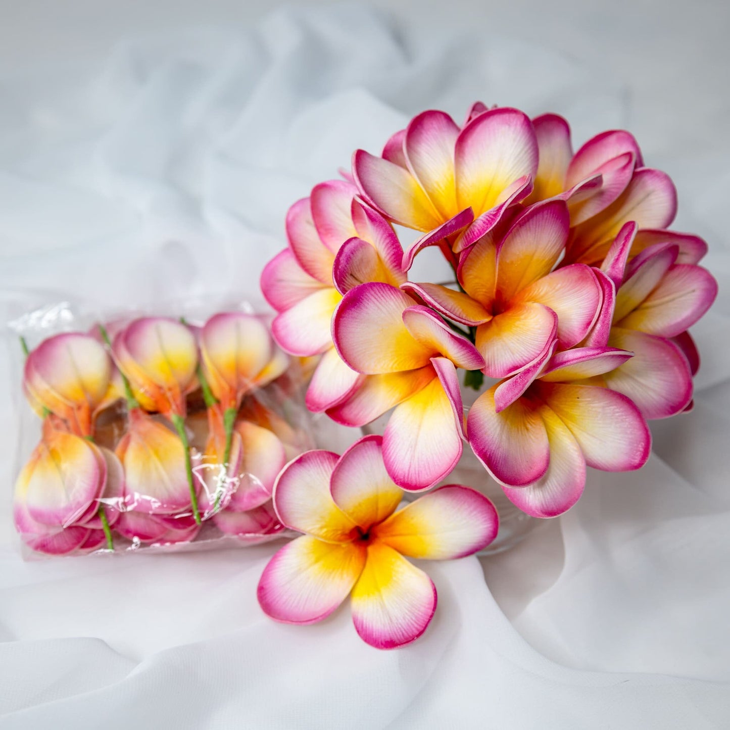 artificial Sunset Pink Frangipani Flowerheads in clear vase