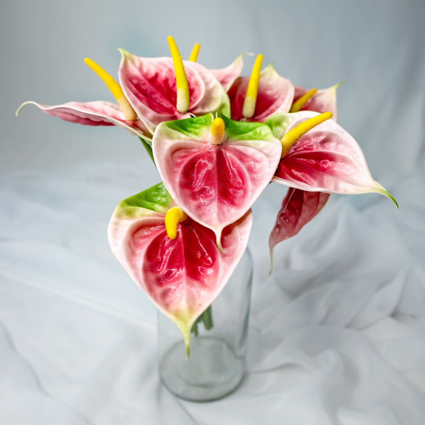 artificial Pink/Green Small Anthuriums in clear glass vase