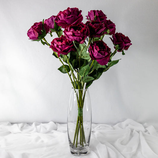 artificial cranberry david Austin roses placed in clear glass vase