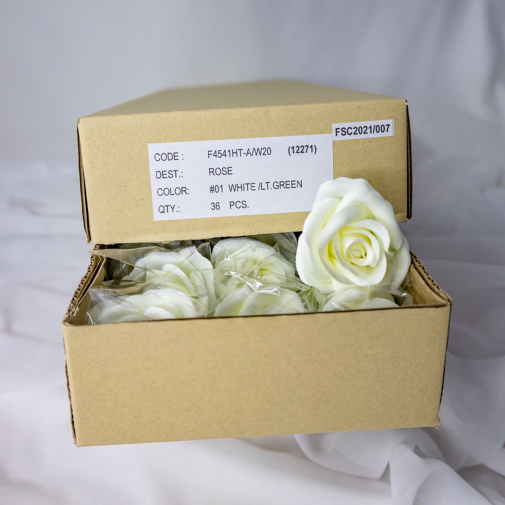 artificial white velveeten roses inside the box