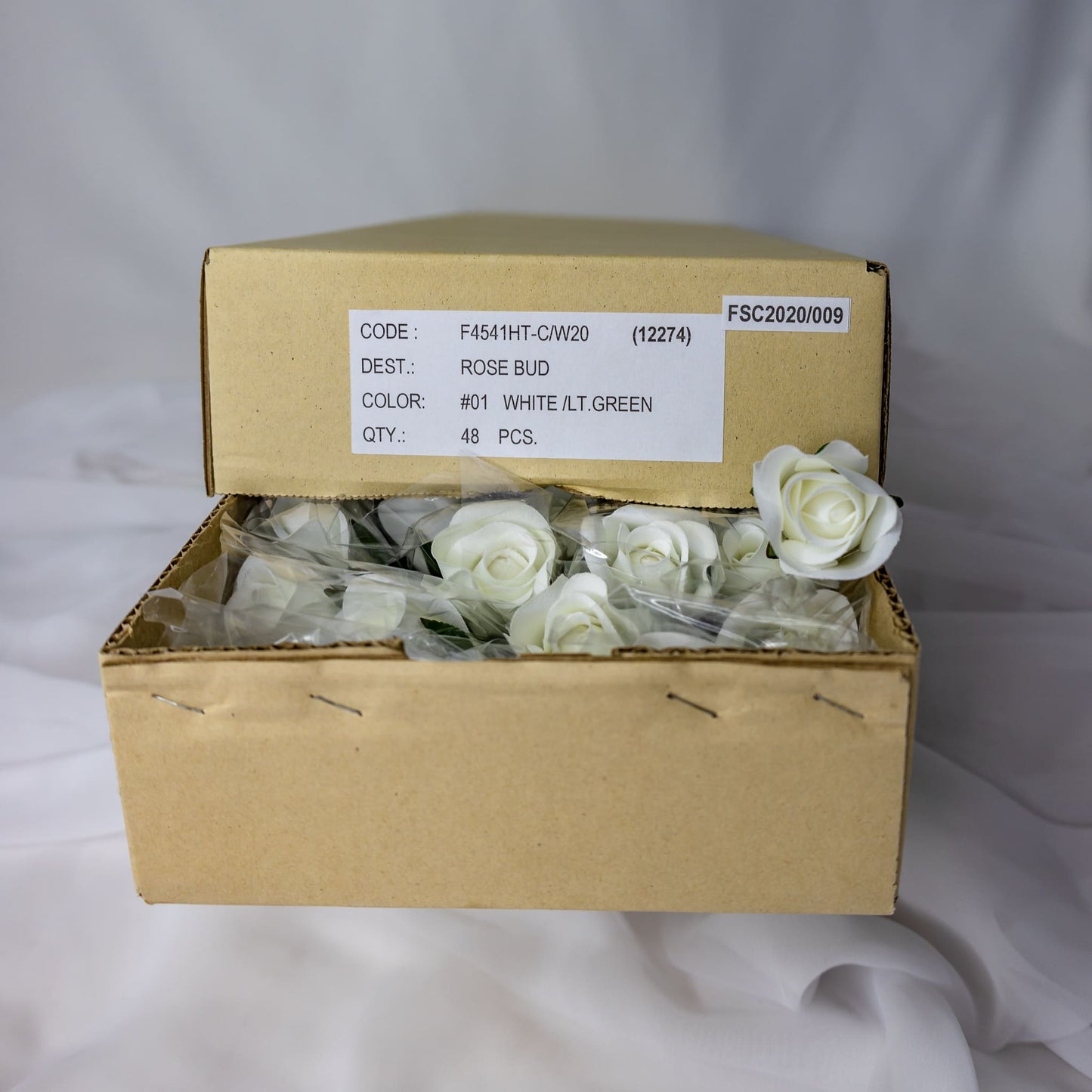 artificial white velveeten rose buds inside the box