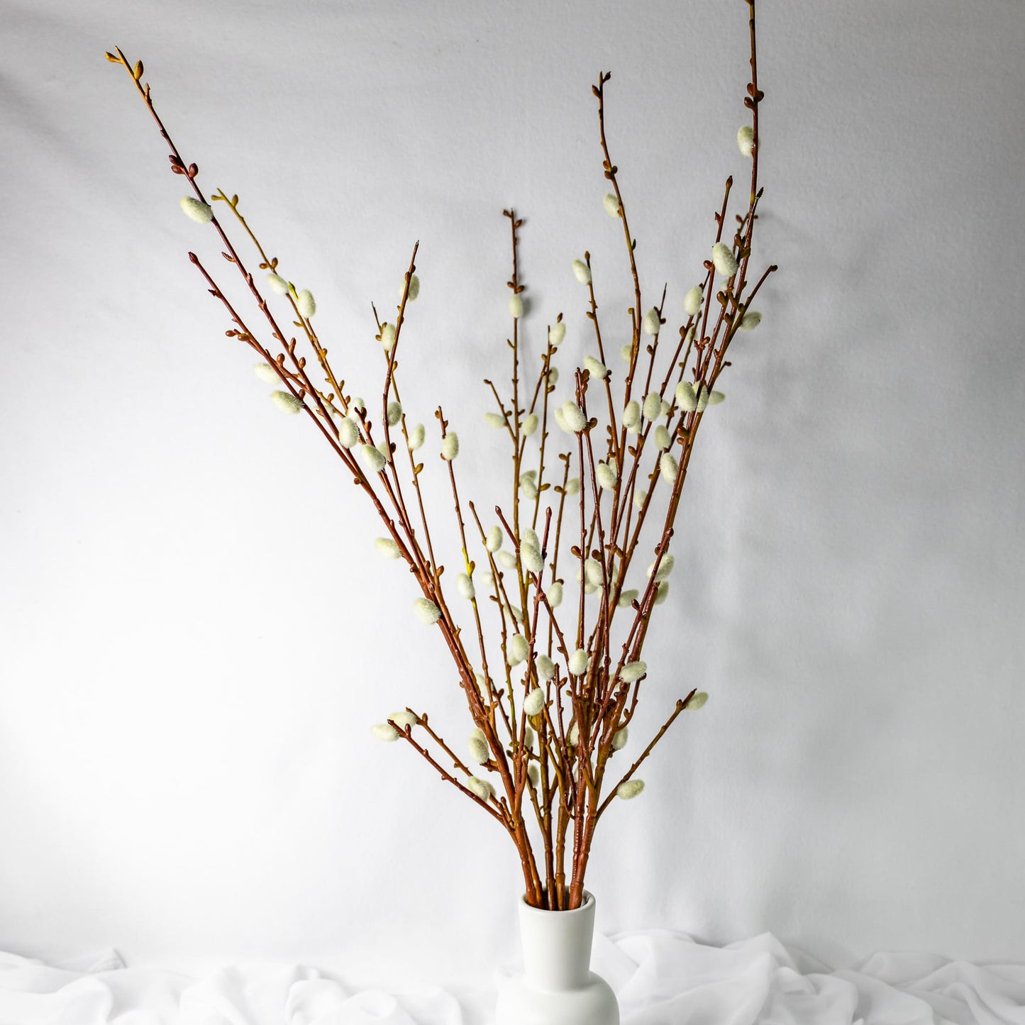 artificial willow branch in white vase