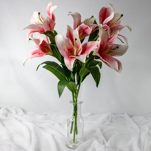 Artificial Pale Pink Oriental Lilies in clear glass vase