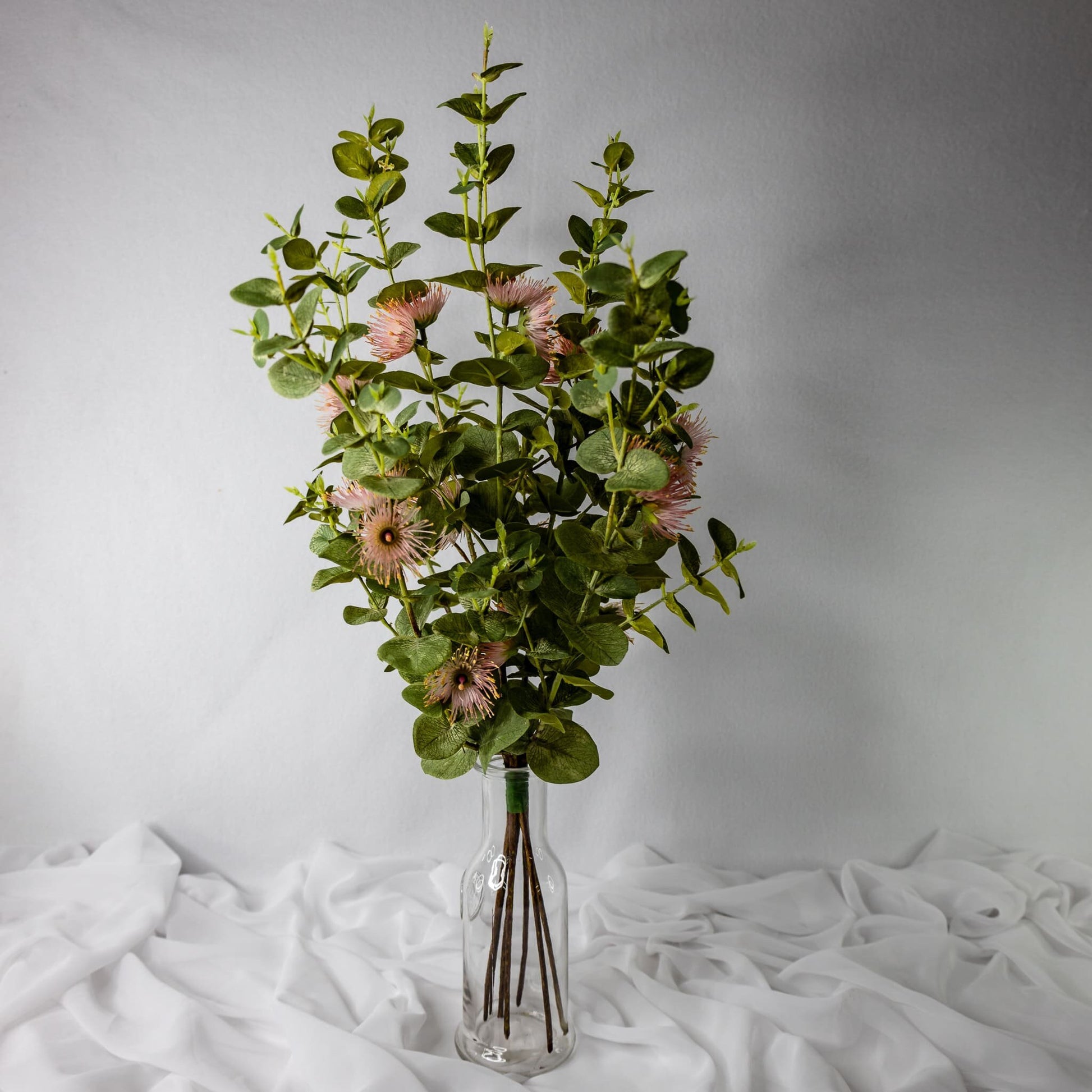 Artificial Pink Flowering Gum Blossom in clear glass vase