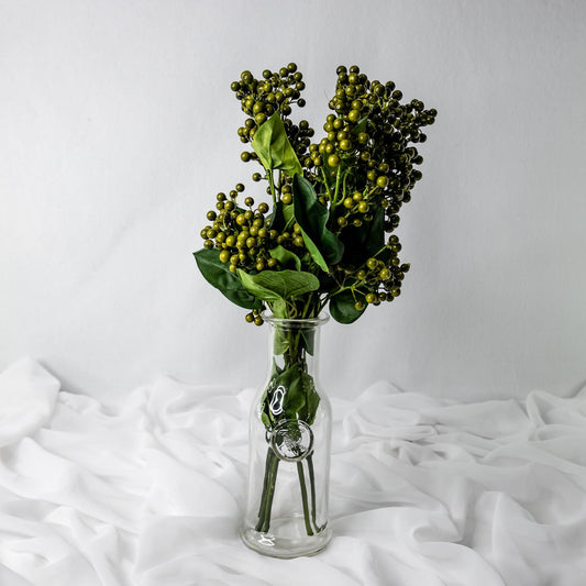 artificial green berry in glass vase