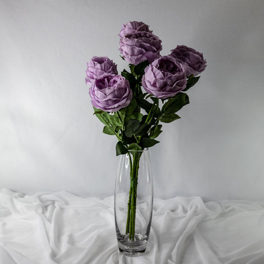 artificial vintage lilac david austin soft roses in open bloom placed in transparent glass vase