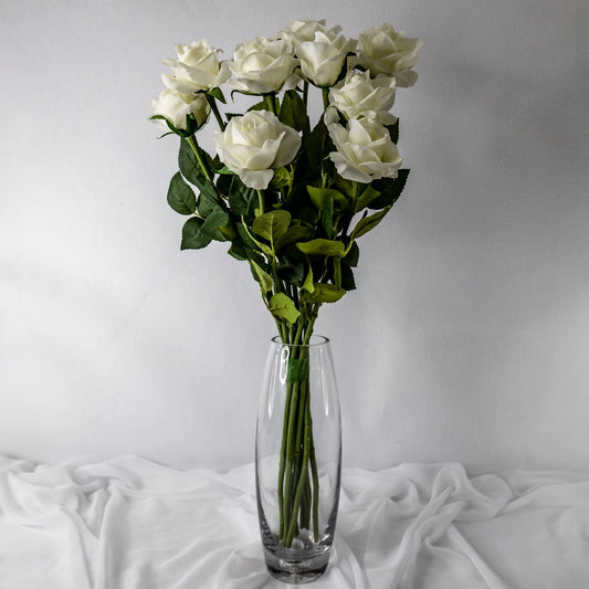 artificial white open bloom roses in transparent glass vase