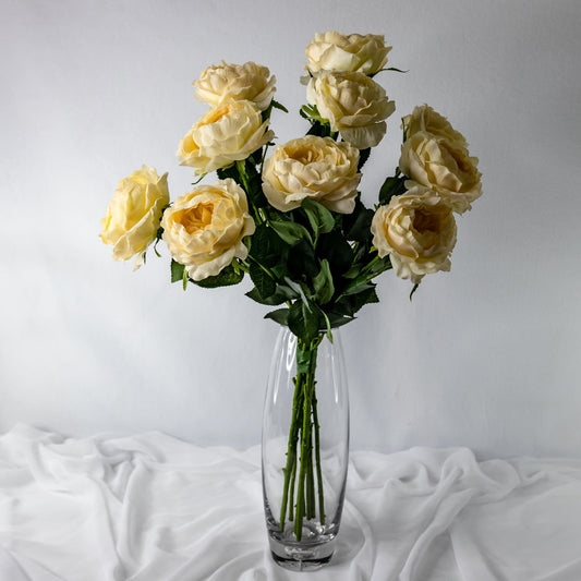 artificial pale peach david austin roses placed in transparent glass vase